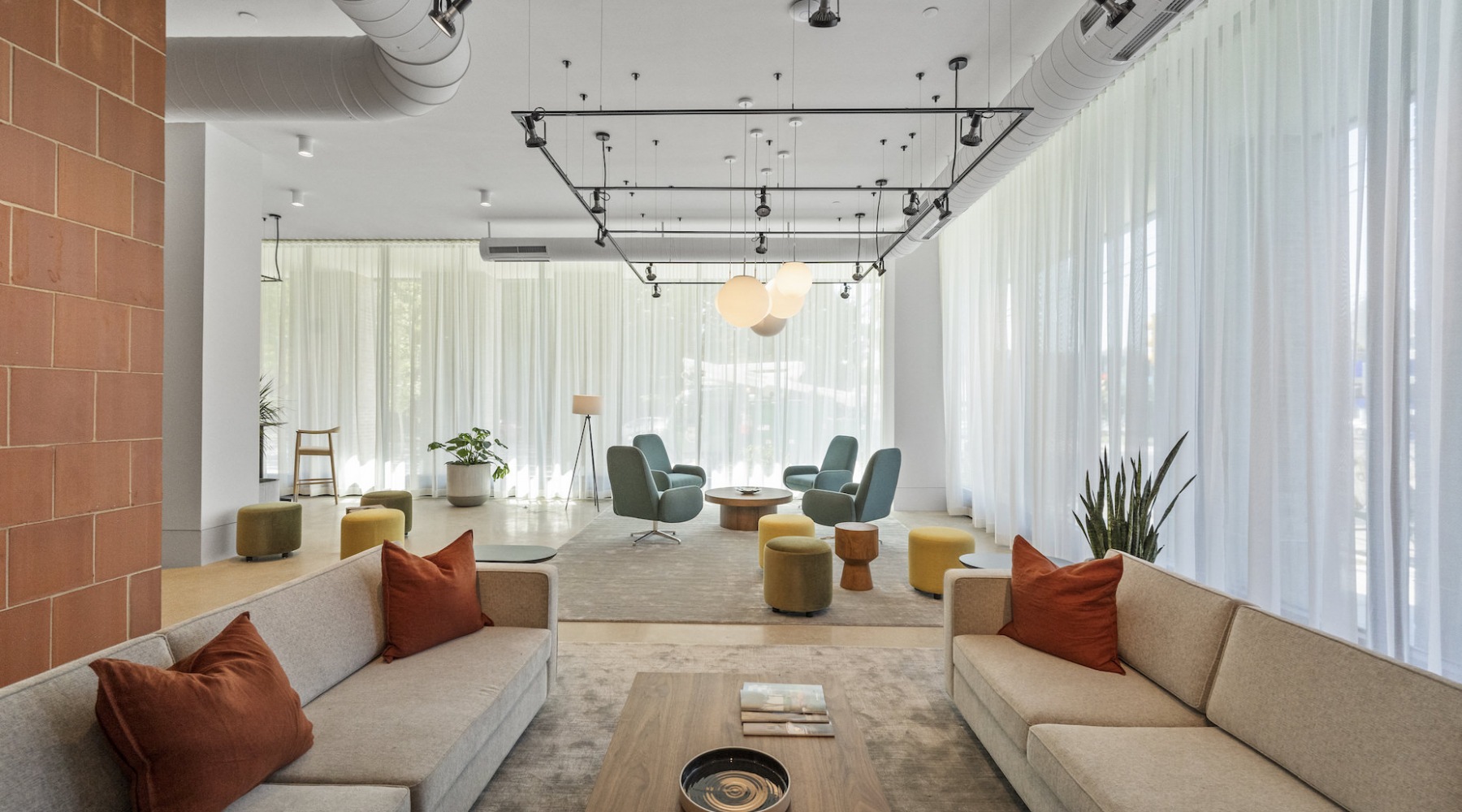 Couches and chairs setup in co-working lounge at The Clark modern apartments in Philadelphia
